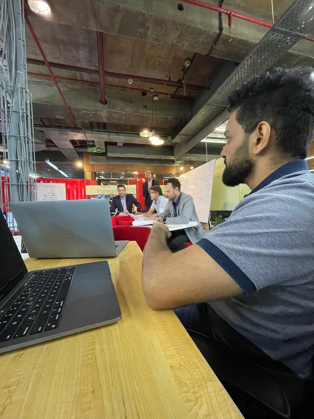 Working on a laptop inside a warehouse